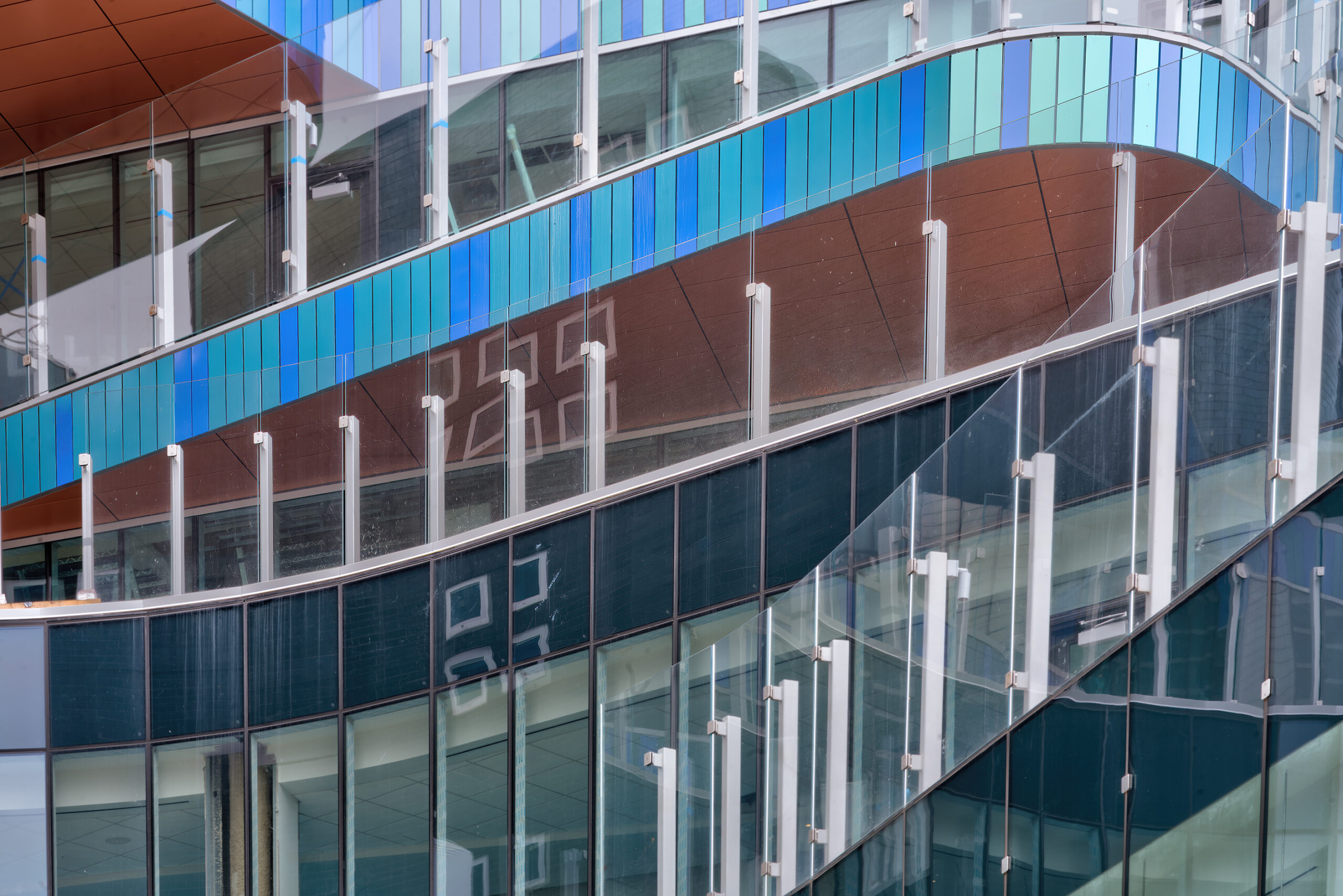 Curved balconies with glass railings attached to Connecticut Children's Hospital main building.